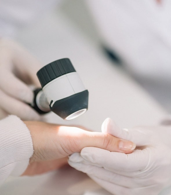 Dermatologist inspecting a patient's hand