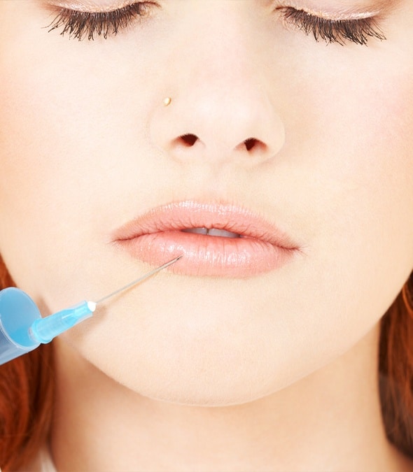 Dermatologist injecting a patient's lip