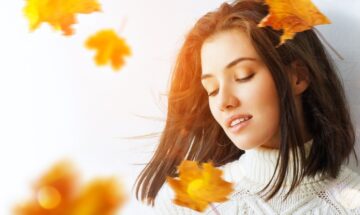 A Young Woman With Smooth Skin Surrounded By Fall Leaves