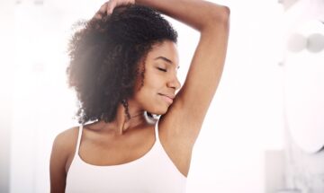 Shot Of An Attractive Young Woman Smelling Her Armpits During Her Morning Beauty Routine