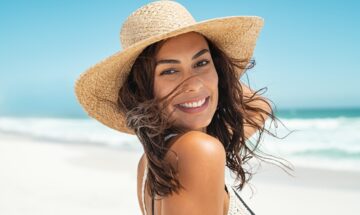Beautiful Girl With A Straw Hat At The Beach